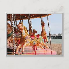 a merry go round at the beach with people on it and an image of brighton in the background