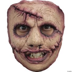 a man's face with blood on the skin and teeth is shown in this creepy mask