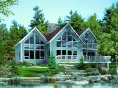 this is an artist's rendering of a house in the woods with water and trees