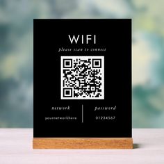 a black and white business card with a qr code on the front that says wifi