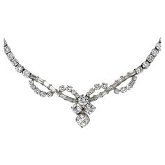 Ladies diamond necklace in 18k white gold setting. Stamped 18k and weighs 22 grams gross weight. Most of the diamonds are round brilliant with a few baguette cuts. The center diamond is .95 carats, J to k color Si2 clairity. The other three side diamonds average H color, VS clarity, .42ct, .46ct, .48ct. The small diamonds average G,H, i color, mostly VS clarity with a few Si clarity. There is approximately 6.50 total carats of smaller diamonds, 8.81 carats for the whole necklace. The necklace me White Gold Diamond Necklace, White Diamond Necklace, Diamond Drop Necklace, Gold Heart Bracelet, White Gold Pendant Necklace, Gold Diamond Necklace, Bezel Set Diamond, Women Diamond, Drop Necklace