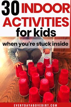 a child sitting on the floor surrounded by red cups with text overlay reading 30 indoor activities for kids when you're stuck inside