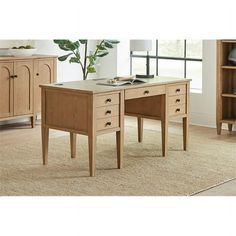 a wooden desk sitting on top of a carpeted floor next to a book shelf