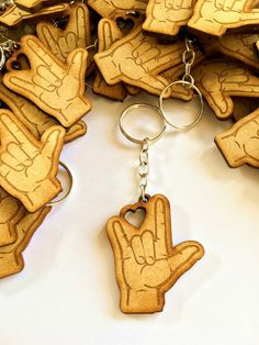 several wooden key chains with hand prints on them