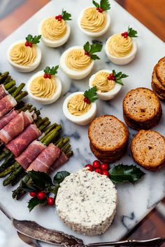 an assortment of appetizers on a marble platter