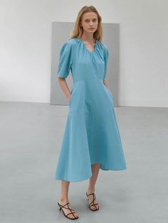 Editor's NotesThis dress is made of polyester. It features a volume sleeve and A-line detail which makes the dress more feminine and romantic. The natural flare creates a feminine and stylish mood. - Classic design long-length dress- Curved neckline detail - Dropped shoulder and lightweight - Shirring detail on the neckline Measurements(in.) Size: Size (55/66) - Total Length: 46.45 in. / 46.85 in.- Chest: 36.22 in. / 37.80 in.- Waist: 28.74 in. / 30.31 in.- Sleeve: 21.65 in. / 22.04 in. *Model info: Height 5' 80, Bust 30.70, Waist 22.83, Hip 35.03, Wearing a size 55 or Free size                    Height 5' 67, Bust 30.70, Waist 21.25, Hip 34.25, Wearing a size 55 or Free size Spring Voluminous A-line Dress, Spring Puff Sleeve Dress With Draped Balloon Sleeves, Formal Puff Sleeve Midi Dress For Spring, Spring Dress With Draped Balloon Sleeves, Feminine A-line Midi Dress With Pleated Sleeves, Chic Summer Puff Sleeve Dress With Draped Sleeves, Evening A-line Puff Sleeve Dress For Spring, Spring Formal Bishop Sleeve Midi Dress, Formal Bishop Sleeve Midi Dress For Spring