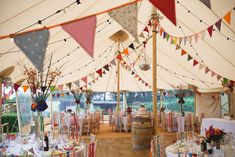 the inside of a tent with tables and chairs