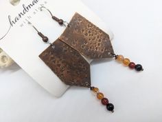 Handmade textured, lightweight copper boho style earrings with 4mm natural orange agate gemstones. Approx. 1.75 inch long, all on quality, surgical stainless steel ear wires. These quality handmade boho style earrings are created by JT Maui Designs. We've had excellent feedback with these stone and stainless pieces from those who often deal with allergies. Love the design, but need a favorite color or gemstone? Just message me as I stock approximately 12 colors in this size. GIFTING? Choose gift Artisan Orange Copper Earrings, Adjustable Nickel-free Rust-colored Jewelry, Adjustable Rust-colored Nickel-free Jewelry, Artisan Copper Beaded Earrings Nickel Free, Unique Rust-colored Earrings With Ear Wire, Unique Rust Earrings With Ear Wire, Bohemian Nickel-free Rust Earrings, Bohemian Rust-colored Nickel-free Earrings, Artisan Metal Earrings In Rust Color