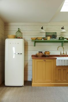 a white refrigerator freezer sitting inside of a kitchen next to a wooden counter top