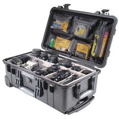 an open black case filled with tools and other items on top of a white background