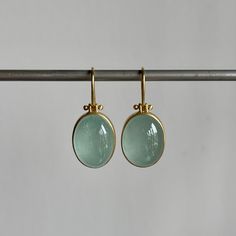 Serene blue aquamarines set in warm yellow gold: an ode to sun & sky in earring form. 18k yellow gold Aquamarines, 24.35ctw, 11mm x 16mm (7/16" x 5/8")Earrings hang 1 1/8" from the ear Each earring weighs 4.8g Gold Aquamarine Gemstone Earrings, Modern Aquamarine Yellow Gold Jewelry, Modern Yellow Gold Aquamarine Jewelry, Gold Oval Blue Topaz Earrings, Classic Gold Earrings With Blue Topaz, Gold Aquamarine Teardrop Jewelry, Handmade Gold Aquamarine Earrings, Gold Aquamarine Drop Earrings, Elegant Gold Jewelry With Aquamarine