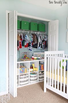 a baby's room with green bins and white crib in the corner