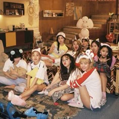 a group of young people sitting on top of a bed in a living room next to each other