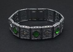 "Antique Art Deco filigree bracelet, wide incorporated in 1896. Filigree links with beautifully engraved. Features 7mm emerald green with bead set crystals The unfoiled green stones are flawless and the hand set crystal chatons show no signs of aging. The rhodium setting is exceptional very clean, with no evidence of any dent, chips or scratches fully functioning measures 7\" long and .75\" width." Formal Silver Bracelet With Emerald, Formal Silver Emerald Bracelet, Victorian Green Bracelets For Gifts, Victorian Green Bracelets As Gift, Victorian Style Green Bracelets For Gifts, Art Deco Green Bracelet For Formal Occasions, Art Deco Green Bracelets For Formal Occasions, Green Art Deco Bracelets For Formal Occasions, Elegant Green Engraved Bracelets