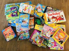 a pile of children's books sitting on top of a wooden floor