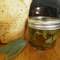 a jar filled with pickles sitting on top of a wooden table next to an oven