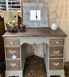 an old desk with drawers and a mirror on top