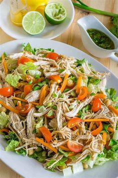 a white plate topped with shredded chicken and vegetables