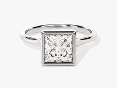 a princess cut diamond set in a white gold ring