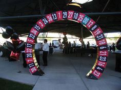 people are standing under an arch decorated with numbers