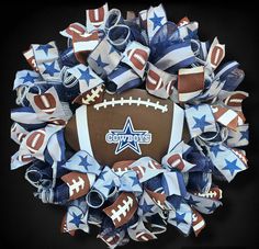 a football wreath with blue, white and red streamers on the front is shown