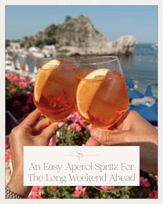 two people holding up wine glasses with orange slices in them and the words an easy appel spritz for the long weekend ahead