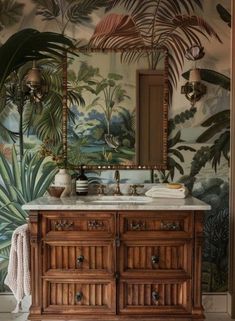 a bathroom with tropical wallpaper and wooden vanity