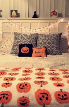 a bed topped with lots of pumpkins on top of it's headboard