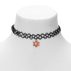 The dangling daisy charm gives off the '90s vibe you crave. It hangs from a gold-tone chain that is attached to a tattoo choker necklace, making this a totally rad choice for an everyday look. Finish: Gold-tone Length: 8'' Closure: Stretch Material: Metal - Claire's Pink Daisy Charm Black Tattoo Choker Necklace Trendy Adjustable Jewelry With Flower Charm, Adjustable Trendy Jewelry With Flower Charm, Adjustable Black Jewelry With Flower Charm, Trendy Adjustable Necklace With Flower Charm, Trendy Metal Jewelry With Flower Charm, Accesorios Aesthetic, Oc Things, Choker Simple, 90s Choker