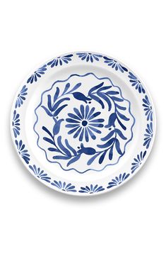 a blue and white plate with an ornate design on the rim, against a white background