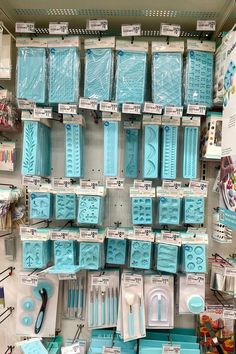 there are many blue items on display in the store, including toothbrushes and combs