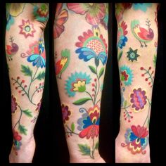 the legs are decorated with colorful flowers and birds