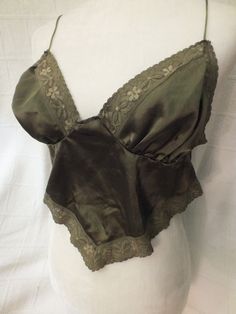 Vintage Green Lace Camisole with triangle shape.  No tags but about a size Medium to Large.  Measurements are: 16" armpit to armpit (can stretch) , cup size C to D.  In vintage condition.  No stains or tears. Vintage Summer Top With Built-in Bra, Green Camisole Crop Top With Built-in Bra, Vintage Sleeveless Top With Built-in Bra, Fitted Green Tank Camisole, Fitted Green Vest Crop Top, Green Fitted Vest Crop Top, Vintage Sleeveless Camisole With Built-in Bra, Summer Vintage Top With Built-in Bra, Fitted Bra With Medium Bust Support, Sleeveless