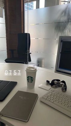 a cup of coffee sitting on top of a white desk