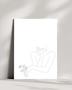 a white card with a drawing of a woman holding a flower