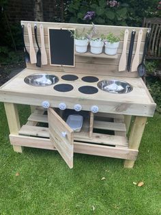 an outdoor kitchen made out of wooden pallets with pots and pans on top