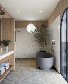 a bathroom with a large tub next to a window