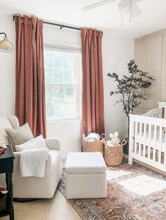 a baby's room with a crib, chair, and ottoman in it