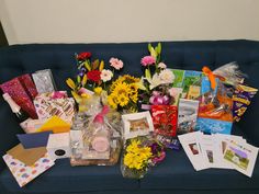 a blue couch covered in lots of flowers and cards