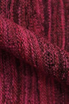 closeup of the texture of a red knitted fabric