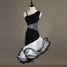 a mannequin dressed in black and white dress with crystal details on the bust