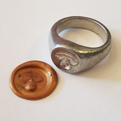 This signet ring is cast in lead-free pewter. The ring size when cast is 6.75. The sealing image is a bolete mushroom.       This is part of a series of signet rings I am making cast from lead-free pewter. Each master ring is hand sculpted to give a unique, rustic style, multi-dimensional relief image when used as a stamp to seal, with sealing wax. Wax Stamp Ring, Bolete Mushroom, Wax Seal Ring, Pewter Ring, Signet Rings Women, Food Fruit, Signet Rings, Multi Dimensional, Sealing Wax