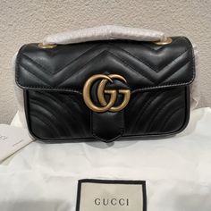 Gg Marmont Matelasse Mini Handbag. Ordered It A Few Months Ago And Have Never Used It. The Sliding Chain Strap Is Still Wrapped. Could Be Used As A Crossbody Or Shoulder Bag. Comes With Everything In The Pictures. Box Not Included. Gucci Rectangular Shoulder Bag With Gold-tone Logo, Classic Gucci Shoulder Bag With Gold-tone Logo Plaque, Gucci Rectangular Bag With Gold-tone Logo Plaque, Classic Gucci Bags With Gold-tone Logo Plaque, Elegant Gucci Bag With Gold-tone Logo Plaque, Gold Gucci Party Bag, Gucci Party Bags With Gold-tone Hardware, Trendy Gucci Evening Bags, Gucci Leather Party Bag