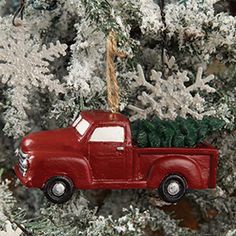 a red truck with a christmas tree in the back