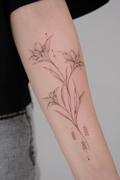 a woman's arm with flowers on it and the word love written in cursive writing