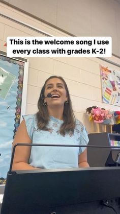 a woman standing in front of a piano with the caption, this is the welcome song i use every class with grade k - 2