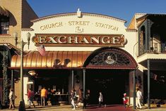 people are walking in front of the church street station and exchange building, which is located on an old brick building