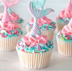 cupcakes decorated with pink, blue and green sprinkles