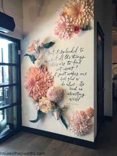 the wall is decorated with flowers and words