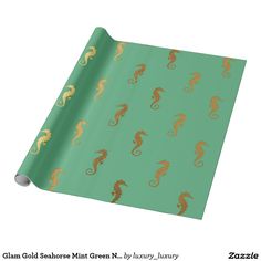 gold seahorses on green background wrapping paper